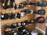 many helmets and gloves hanging on the wall in this room