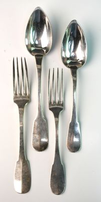 four spoons and two forks on a white surface