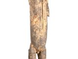 statue of a man with a hat on his head standing on a wooden base