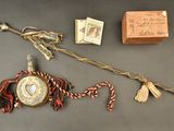a small wooden box and a stick with a picture on it