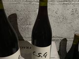 three bottles of wine sitting on a white box
