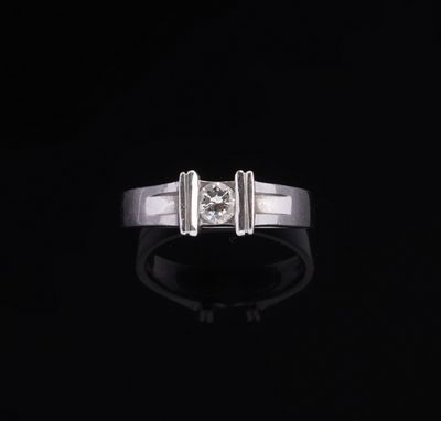 a white gold ring with a diamond on a black background
