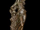 bronze statue of a woman holding a flower in her right hand