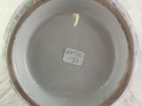 a white bowl sitting on a table with a sticker on it
