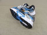 pair of blue and white running shoes sitting on the floor