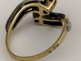 an image of a close up of a gold ring on a white surface