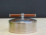 a silver plate with a wooden handle on top of it