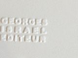 a close up picture of a white plate with a logo on it