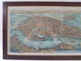 an old map of a city in a wooden frame hanging on a wall
