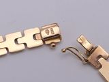 an image of a gold bracelet with a clasp and a clasp