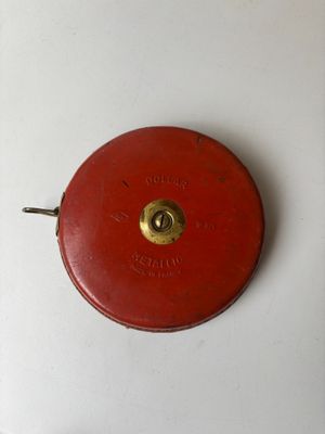 a red clock that is on a white table