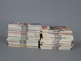 several books stacked on top of each other on a table