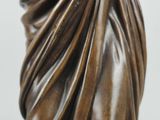 bronze statue of a woman with a shaw around her head