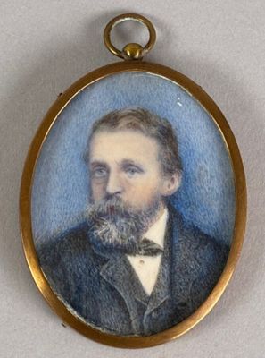 portrait of a man with a beard in a suit and bow tie