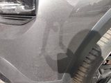 a close up of a car ' s front bumper and tire
