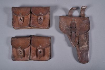 three pieces of leather are shown on a gray surface