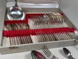 a box with silver and red spoons and spoons in it