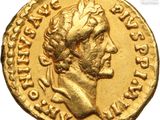 a gold coin with a head of a man wearing a crown
