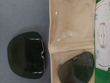 a green case with a pair of sunglasses and a cell phone