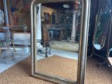 a mirror that is sitting on the floor in a room