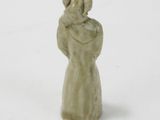 figurine in the form of a woman with a hat on her head