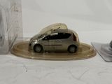 a toy car that is sitting on a plate next to a mouse