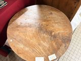 a wooden table with a red table cloth on it