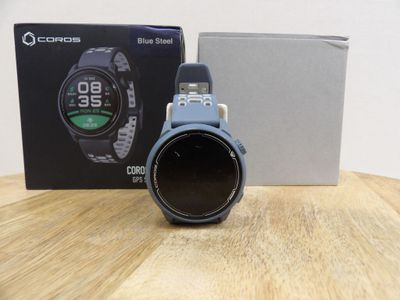 a close up of a watch sitting on a table next to a box