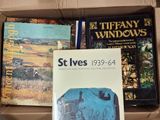 many books in a box that are sitting on top of each other