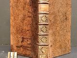 an old book that is sitting on a table next to a pair of scissors