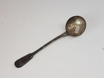 a silver spoon with a spoon handle on a white surface