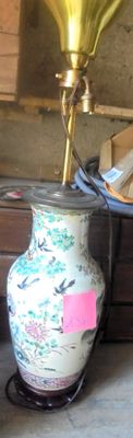a vase that is sitting on a table with a horn on it