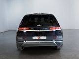 the rear end of a black suv parked in a white room