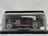 a model of an old car under a glass case