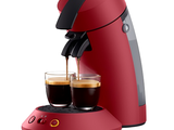 an image of a red coffee maker with two cups of coffee