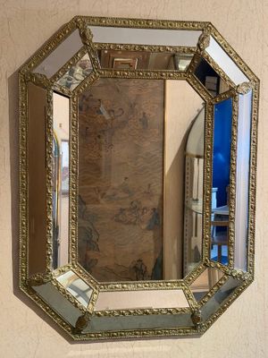 a mirror hanging on the wall above a sink