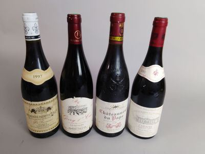 quatre bouteilles de vin sont alignées sur une table