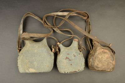 three old purses sitting on top of a table next to each other