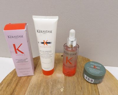 un flacon de Kérastase à côté d'une boîte de produits de soins capillaires