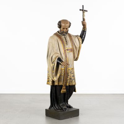 a statue of a man holding a sword and wearing a robe