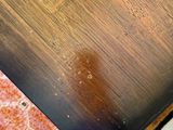 a wooden table with a glass of wine on top of it