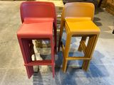 three different colored stools sitting on a floor