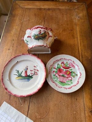 three plates and a bowl on a wooden table