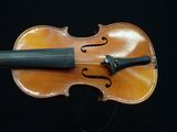 a violin with a bow on a black background