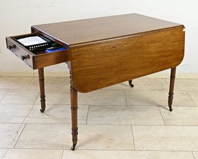 a small wooden table with a drawer on top of it