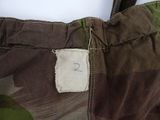 a close up of a camouflage bag with a tag on it
