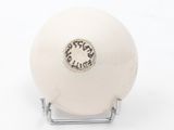 a white ball on a metal stand on a white surface