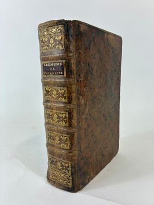 an old book sitting on top of a table next to a white background