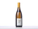 a bottle of white wine sitting on top of a table