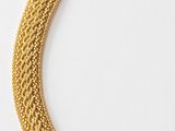 a gold necklace with a chain that has a clasp on it